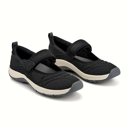 Hook-and-loop strap across the instep of a knit shoe