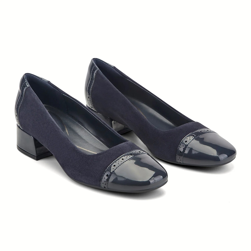 Block heel under a patent dress pump