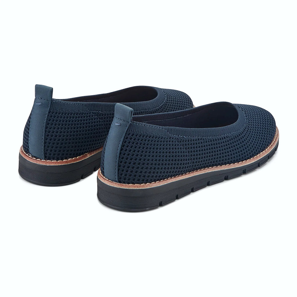 Contrast-stitched trim along the sole of a knit slip-on