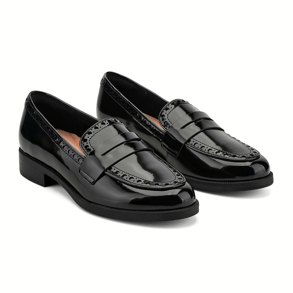Perforated trim along the collar of a penny loafer