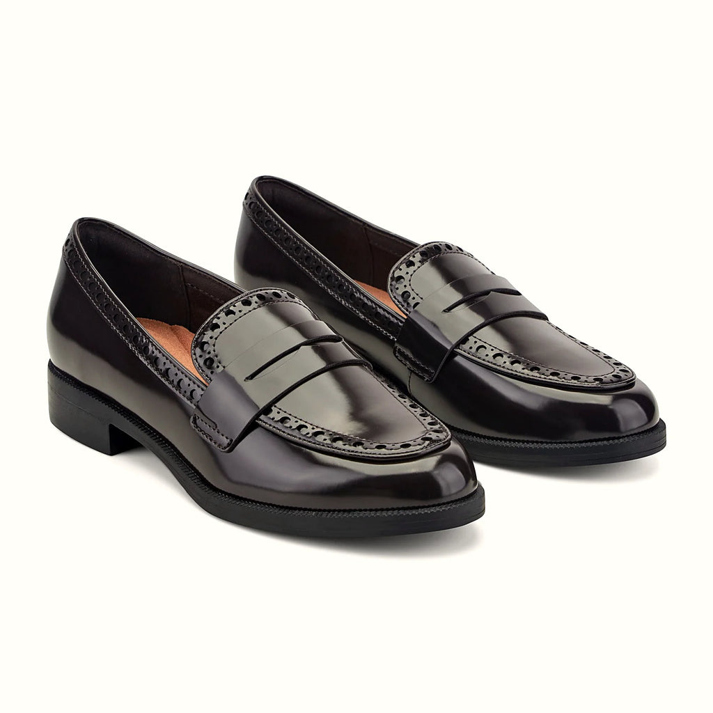 Perforated trim along the collar of a penny loafer