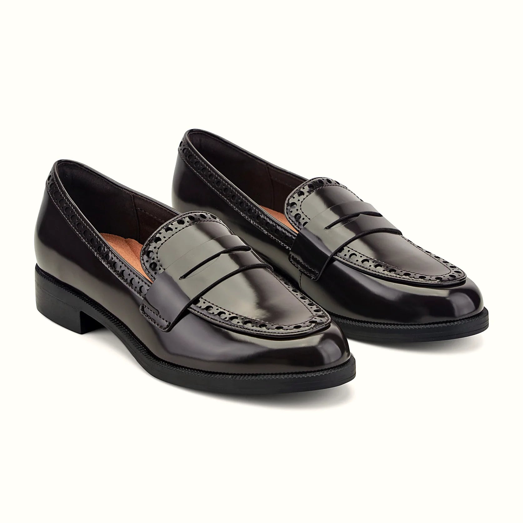 Perforated trim along the collar of a penny loafer
