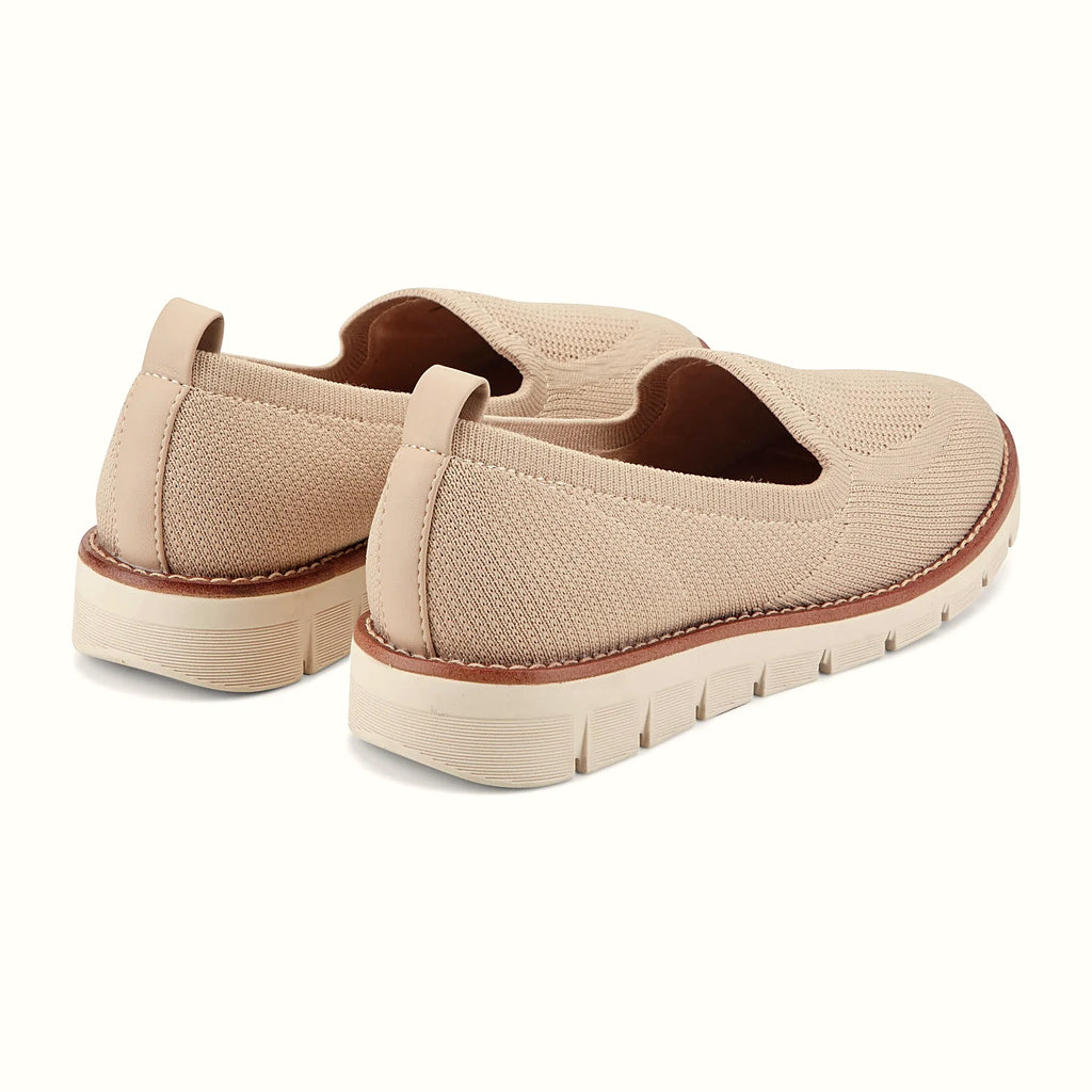 Pull tab at the heel of a knit slip-on flat