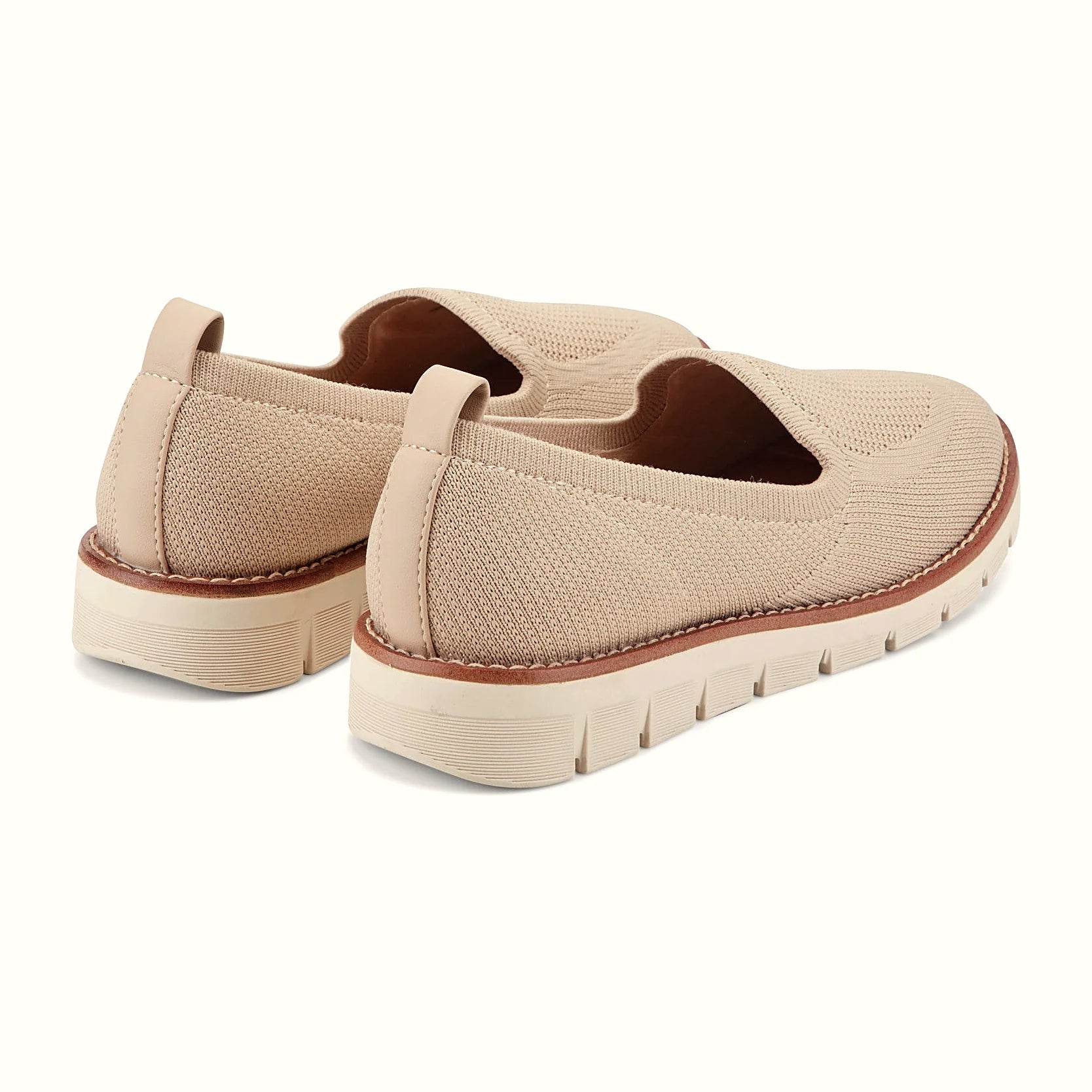 Pull tab at the heel of a knit slip-on flat