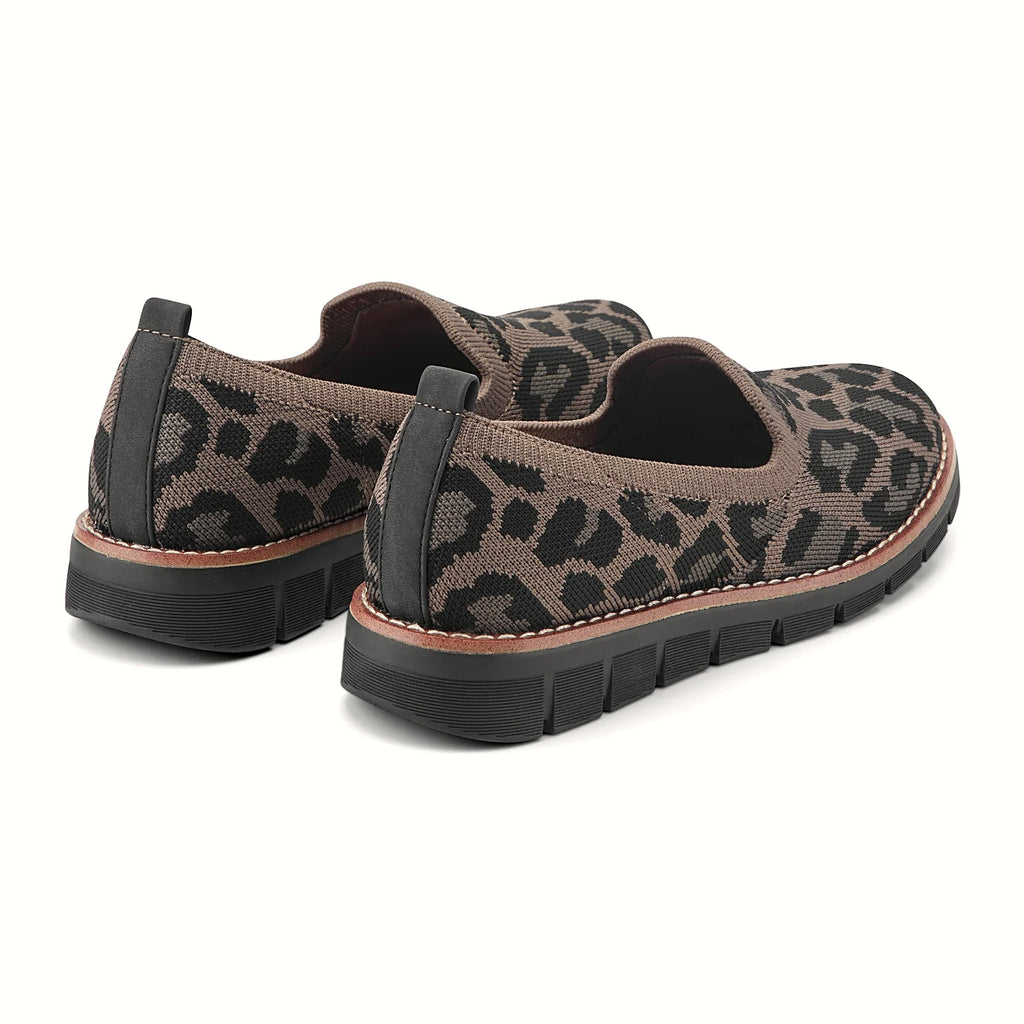 Contrast-stitched trim along the sole of a knit flat