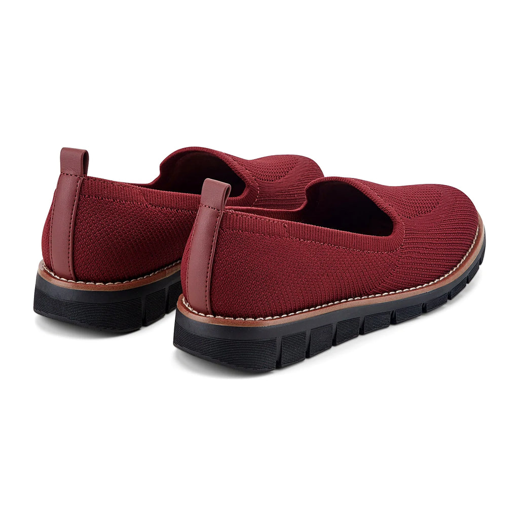 Removable insole lifted out of a knit slip-on flat