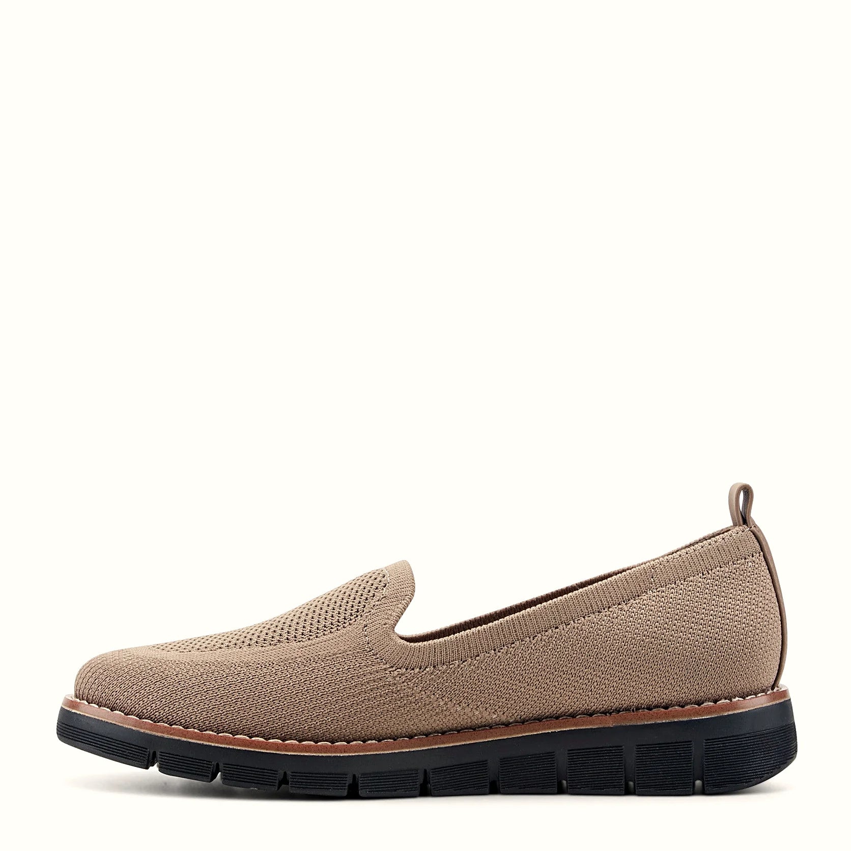 Removable insole lifted out of a knit slip-on flat