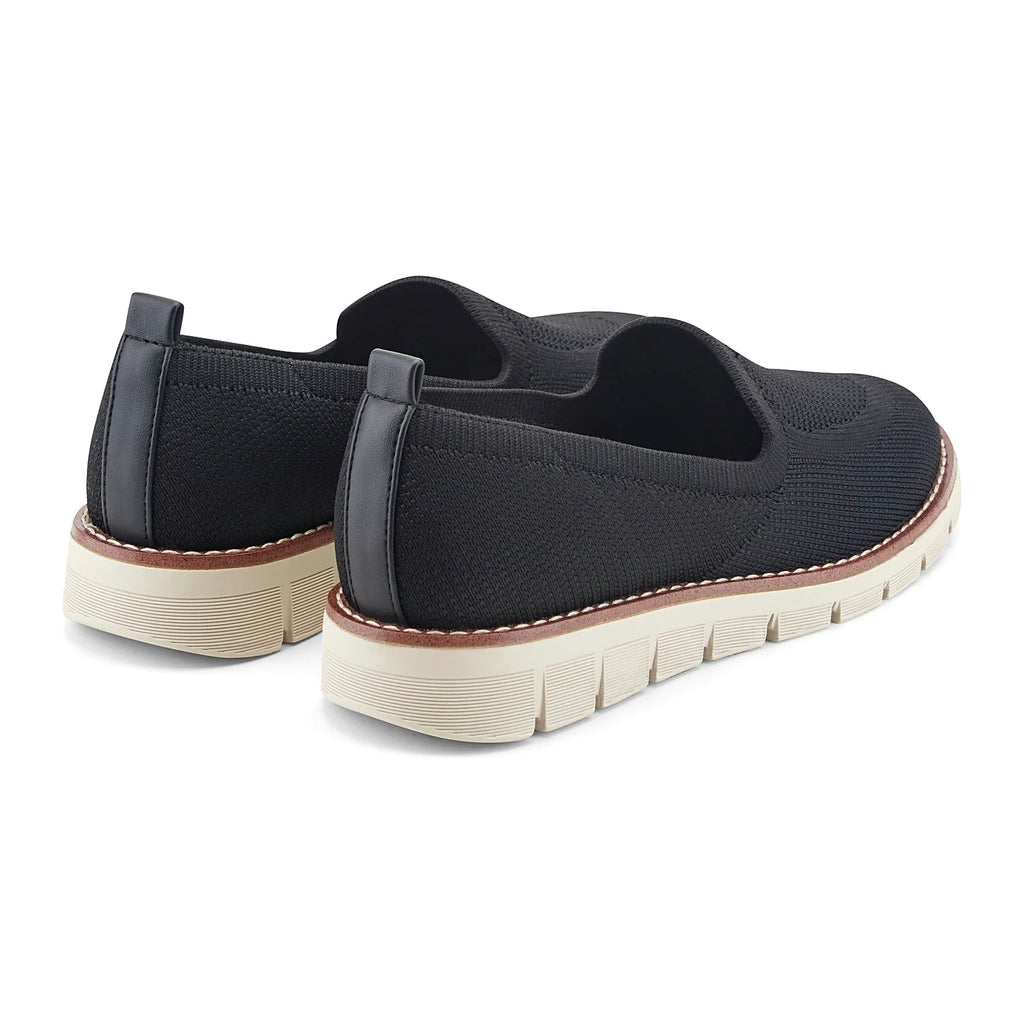 Removable insole lifted out of a knit slip-on flat