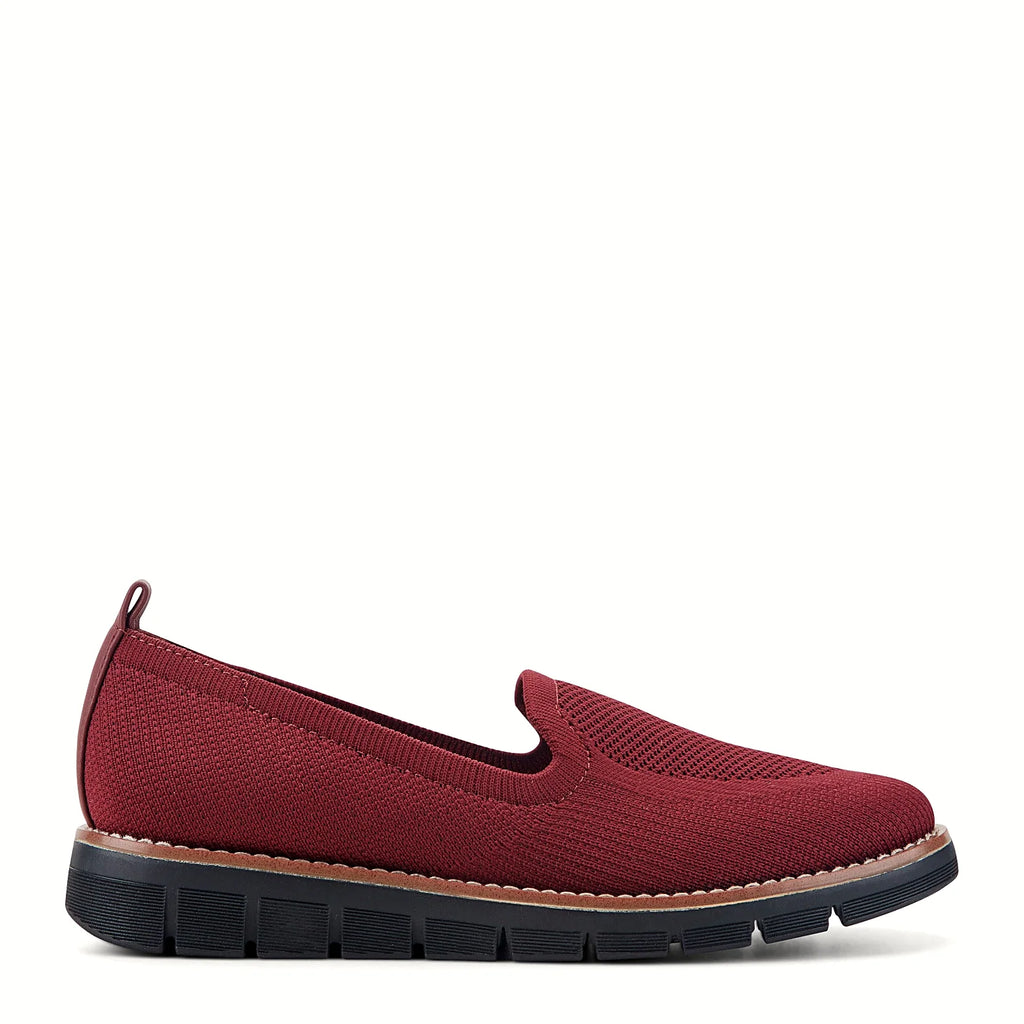 Pull tab at the heel of a knit slip-on flat