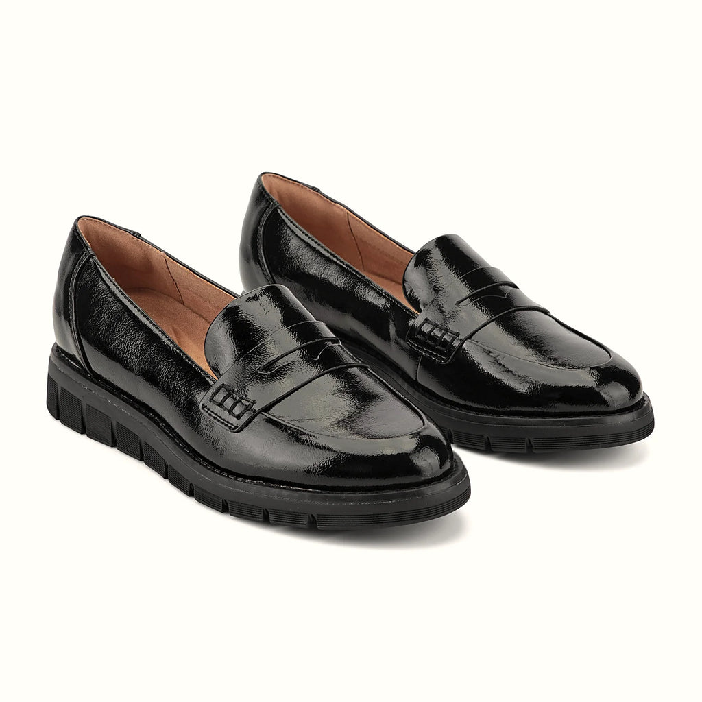 Decorative topstitching tracing the penny slot on a loafer