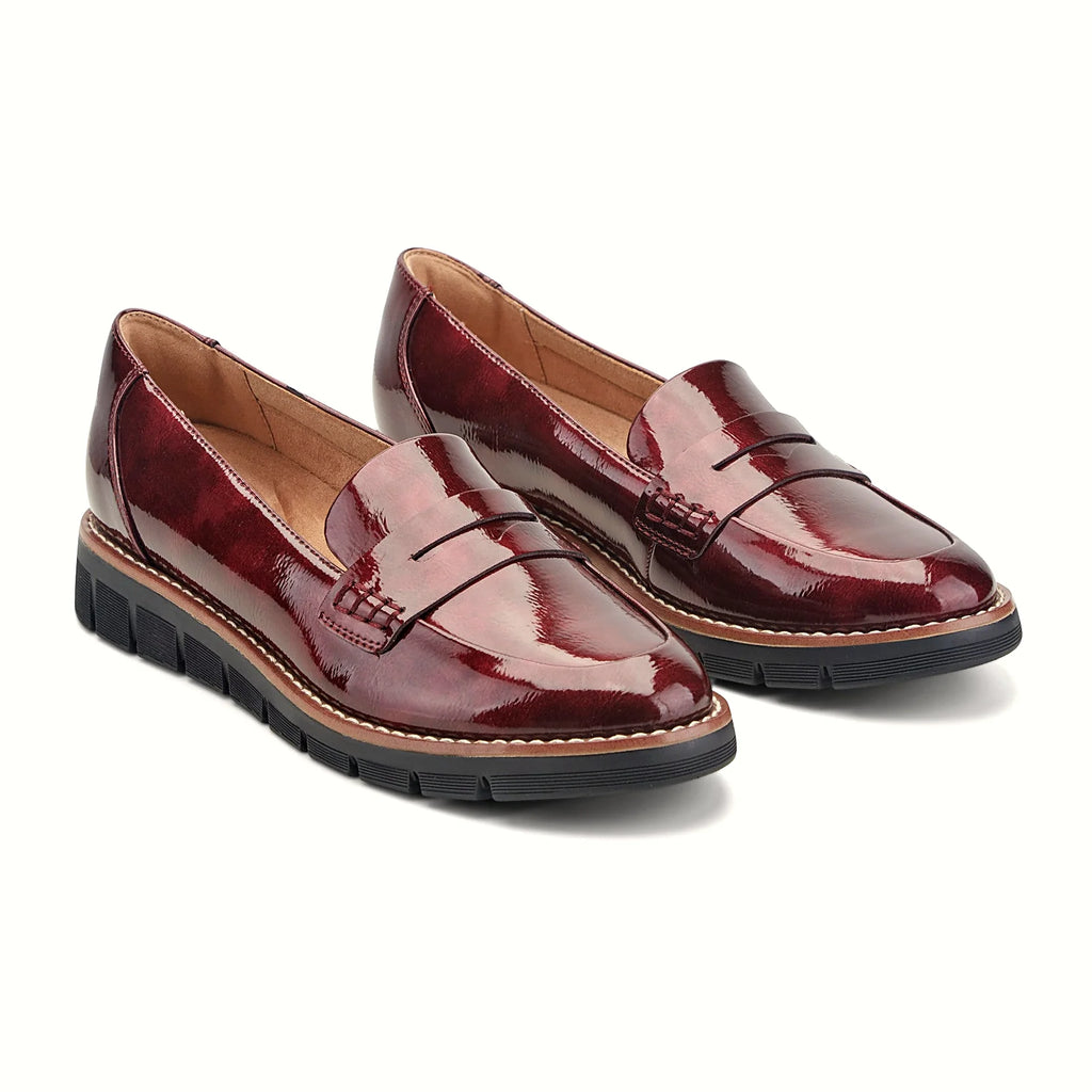 Decorative topstitching tracing the penny slot on a loafer