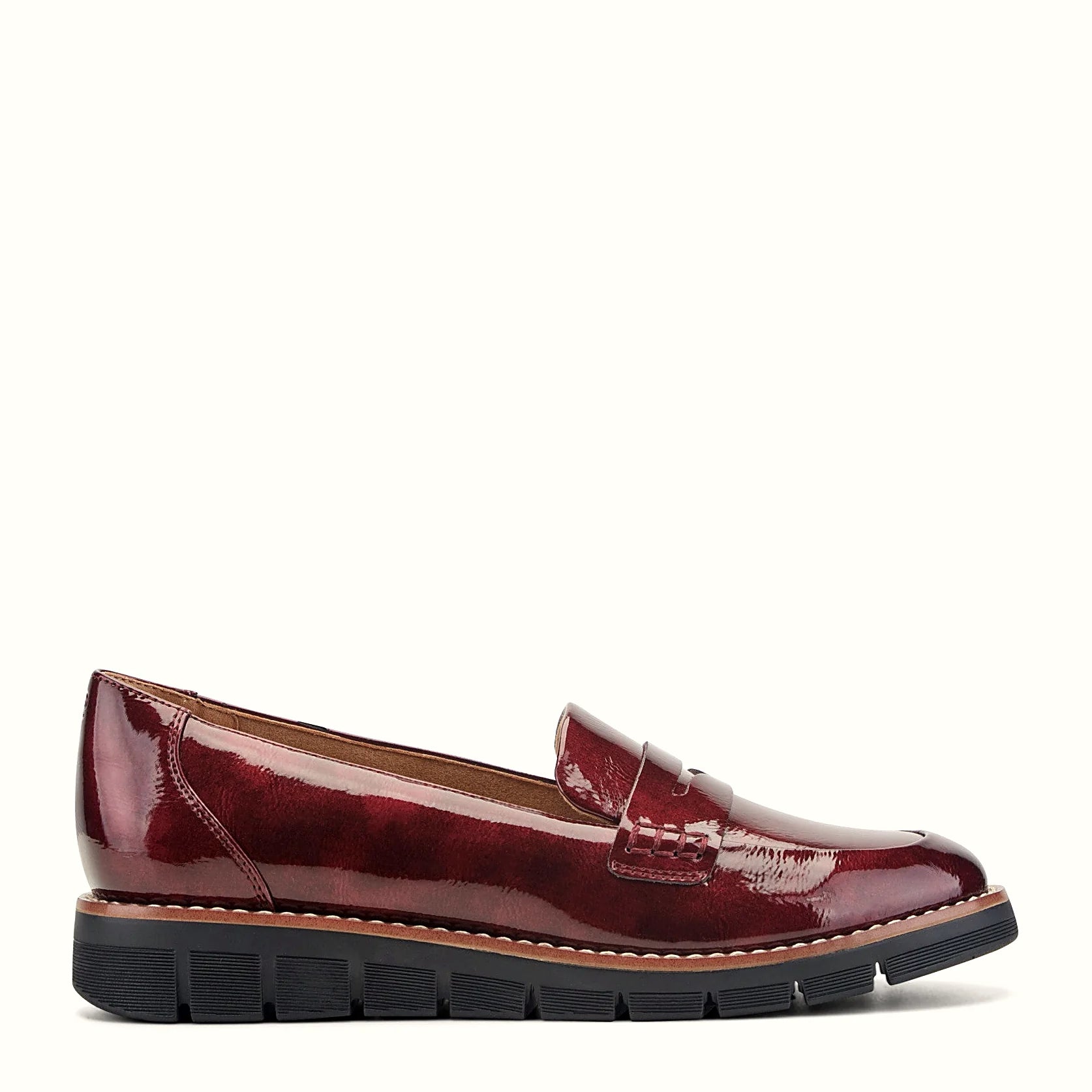 Smooth penny loafer with a strap across the vamp